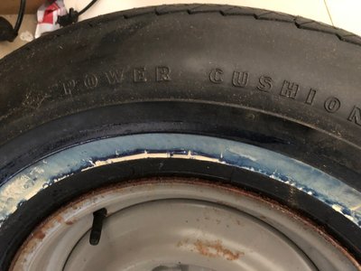 Goodyear Power Cushion 9.15 4 ply whitewall tire.  Some rusted areas around edge of wheel in spots where the jack base was in contact with it.  Blue protective film still present on whitewall.